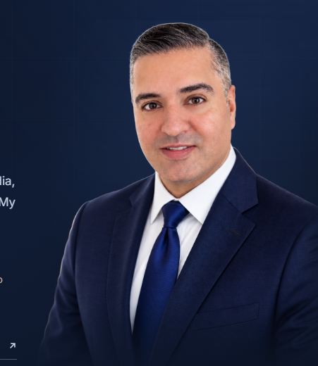 Gaurav Sharma wearing a navy suit and tie